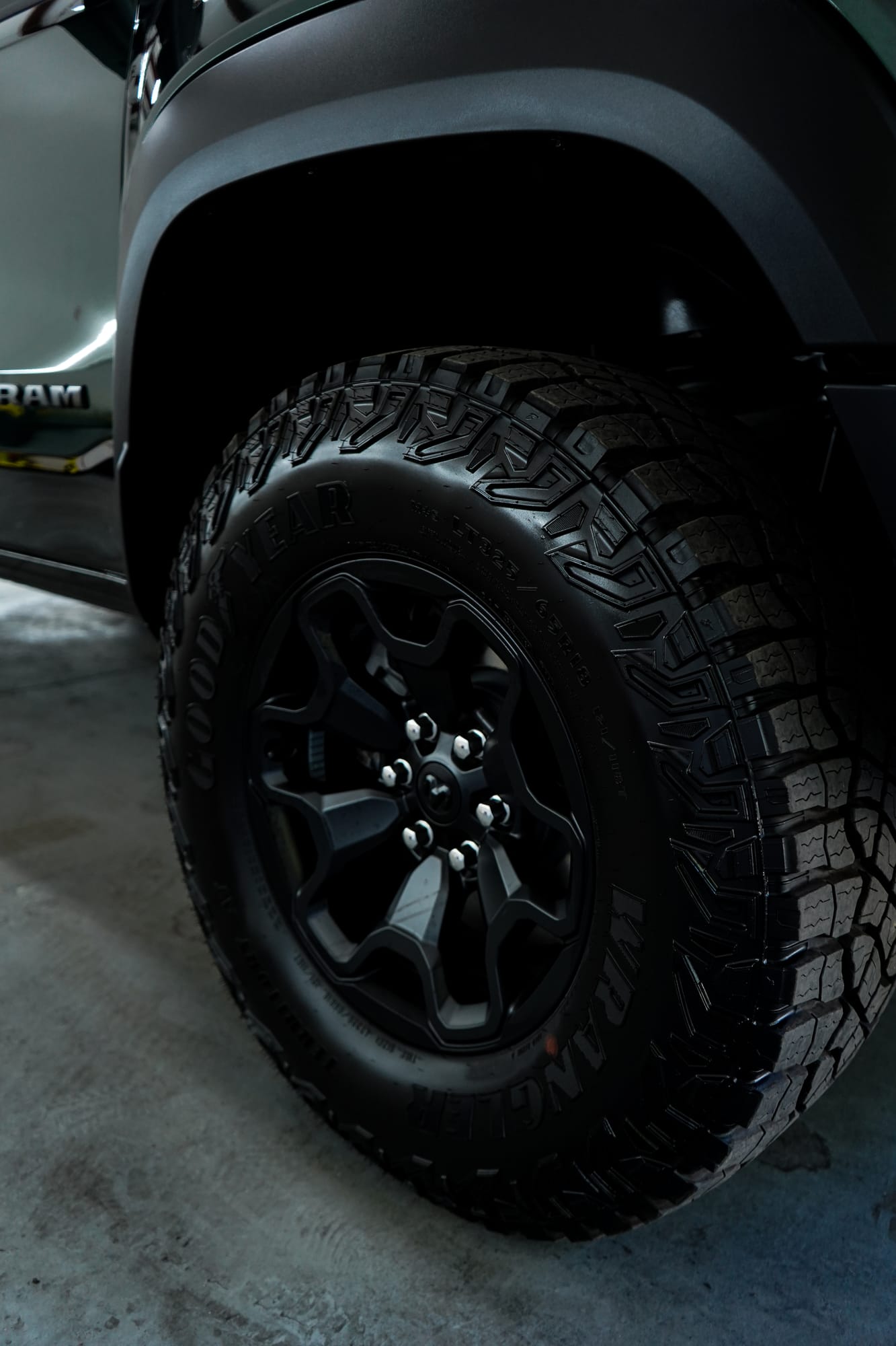 Close up of a ceramic coated black wheel and off-road tire on a pickup